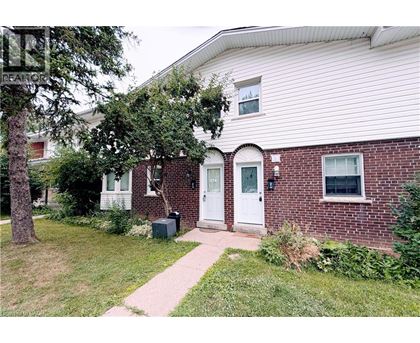 A house with a white door and a brick wall.