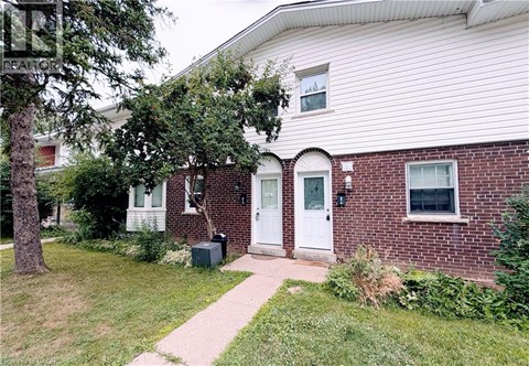 A house with a white door and a brick wall.