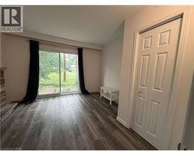 A room with a sliding glass door leading to a garden.