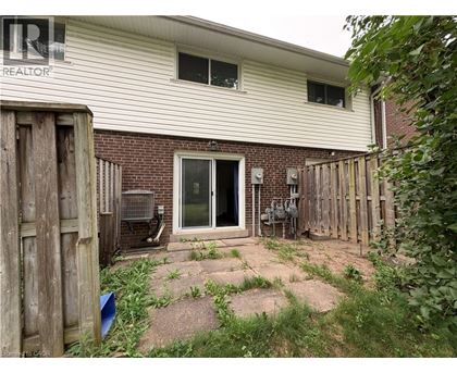 A house with a backyard and a fence.