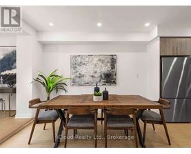 A dining room with a wooden table and chairs.