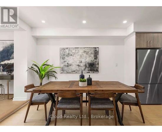 A dining room with a wooden table and chairs.