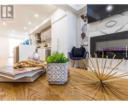 A modern kitchen with a wooden table and a plant on it.