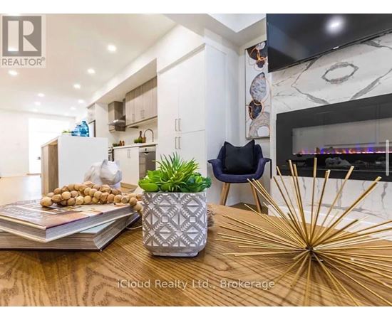 A modern kitchen with a wooden table and a plant on it.