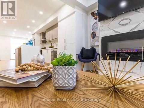 A modern kitchen with a wooden table and a plant on it.