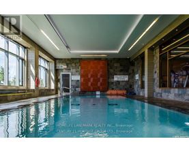 A swimming pool inside a building with a red door and a sign that says "GALLERY WATER".