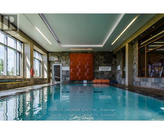A swimming pool inside a building with a red door and a sign that says "GALLERY WATER".