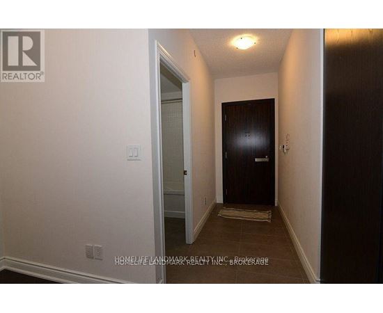 A hallway with a door on the left and a door on the right.