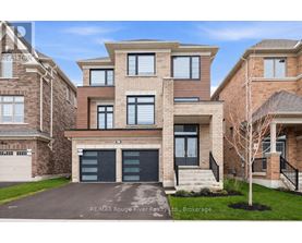 A modern two-story house with a garage is for sale by RE/MAX Rouge River Realty.