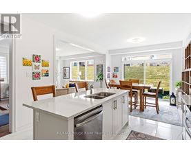 A kitchen with a table and chairs in front of a window.