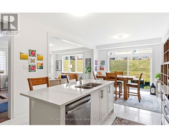 A kitchen with a table and chairs in front of a window.