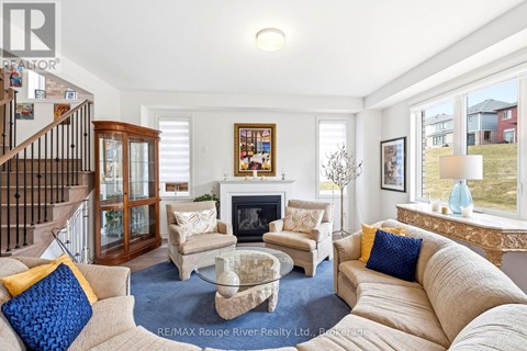 A living room with a fireplace and a painting on the wall.