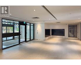 A spacious room with a view of the outside through large windows.