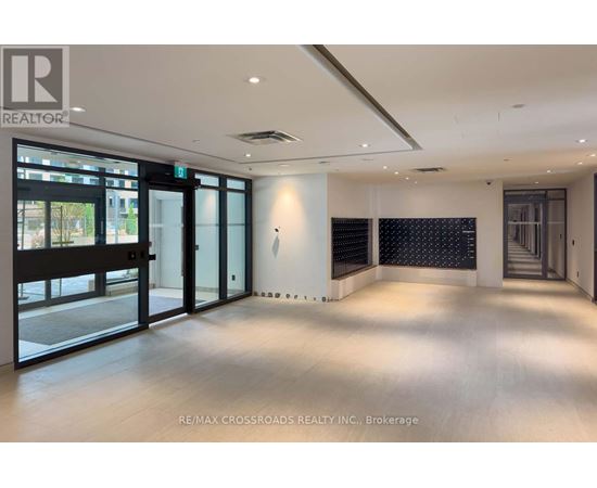 A spacious room with a view of the outside through large windows.