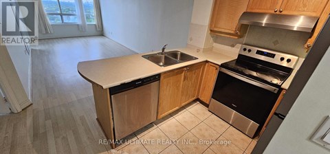 A kitchen with a sink and stove top oven.