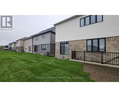 A row of houses with the RE/MAX Community Realty logo in the corner.