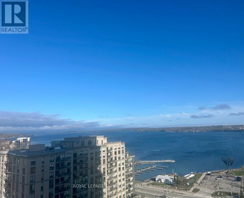 A view of a cityscape with a large body of water and a building with the words "Royal LePage REALTOR" on it.