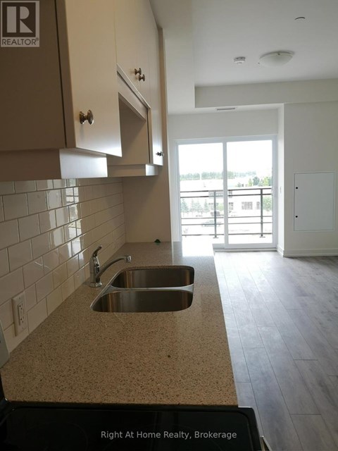A kitchen with a sink and a window.