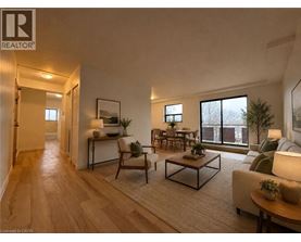 A well-lit living room with a wooden floor and furniture.