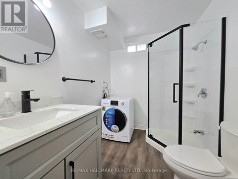 A bathroom with a sink, toilet, and a shower stall.