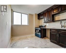 A kitchen with brown cabinets and a white fridge.