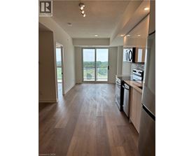 A kitchen with a refrigerator, dishwasher, and oven.