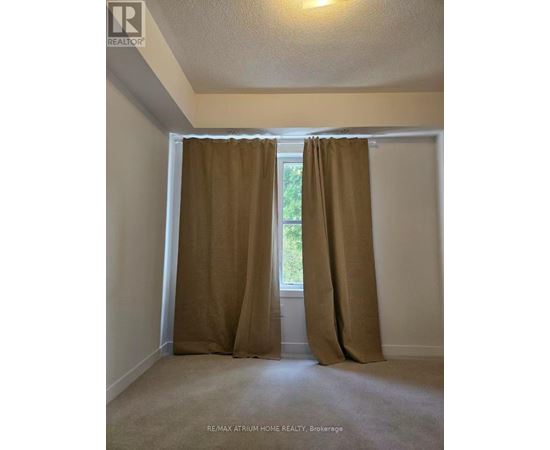 A room with a window covered by brown curtains.