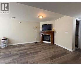 A living room with a television and a fireplace.