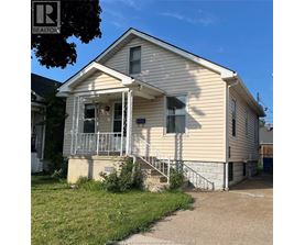 A small house with a porch and a sign that says REALTOR.