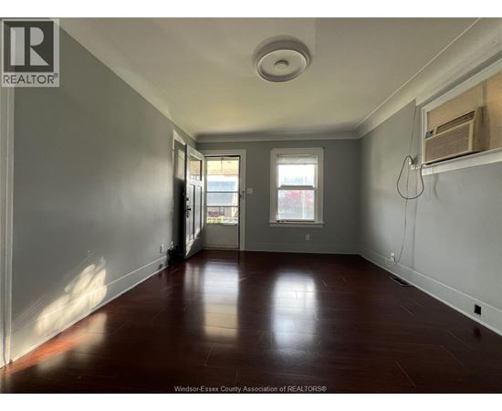A room with a wooden floor and a window.