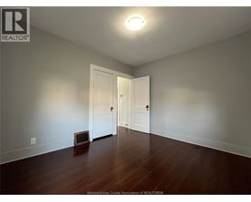 A room with a wooden floor and a white door.