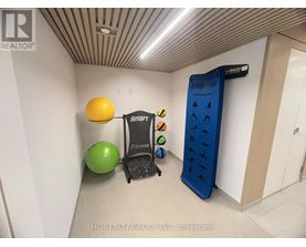 A room with a treadmill, exercise balls and a sign that says Smart Fitness.