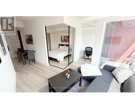 A bedroom with a bed, desk, and chair.