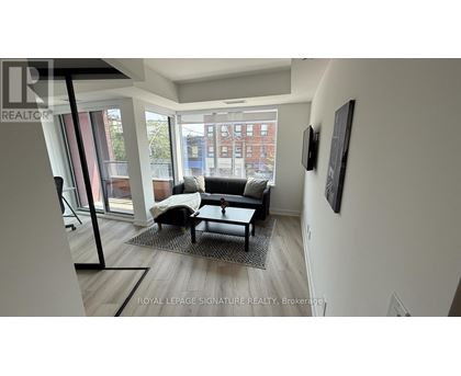 A living room with a couch and a chair.