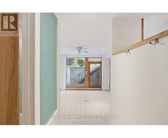 A hallway with a door at the end and a REALTOR sign on the door.