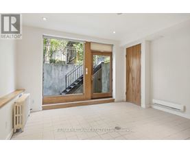 A spacious room with a staircase leading to an outdoor area.