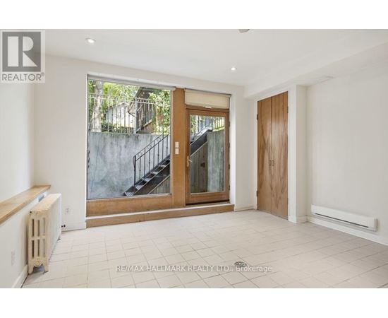 A spacious room with a staircase leading to an outdoor area.