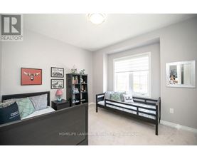 A bedroom with a bed and a bench in it.