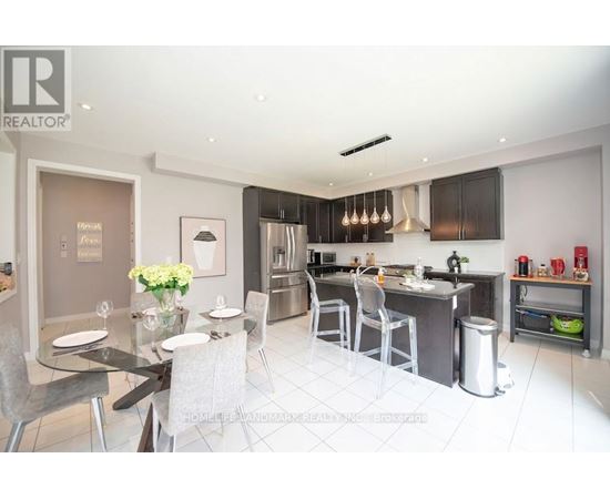 A modern kitchen with a dining table set for two.