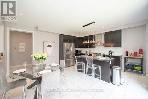 A modern kitchen with a dining table set for two.