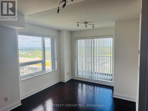 A room with a view of the street through the window.