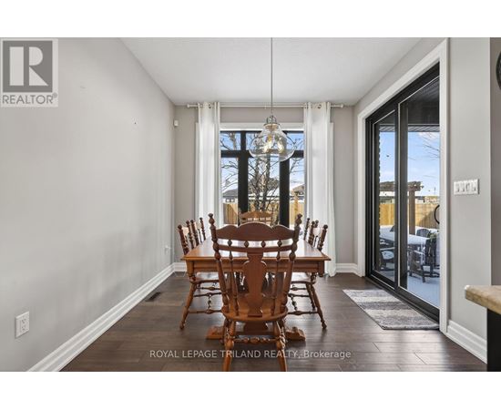 A dining room with a table and chairs.