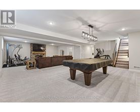 A spacious room with a gym and a staircase.