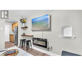 A living room with a flat screen TV mounted on the wall.