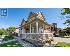 A large, well-maintained house with a brick facade and a covered porch.