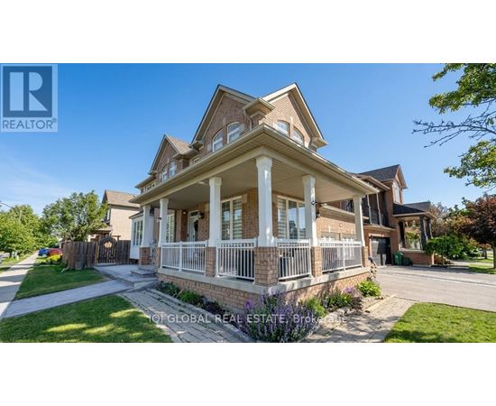 A large, well-maintained house with a brick facade and a covered porch.