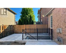 A house with a black gate and a brick wall.