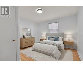 A bedroom with a bed, nightstand, and dresser.