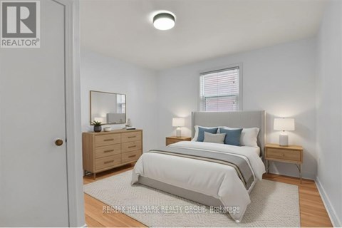 A bedroom with a bed, nightstand, and dresser.
