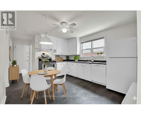 A modern kitchen with white cabinets and a dining table with chairs.